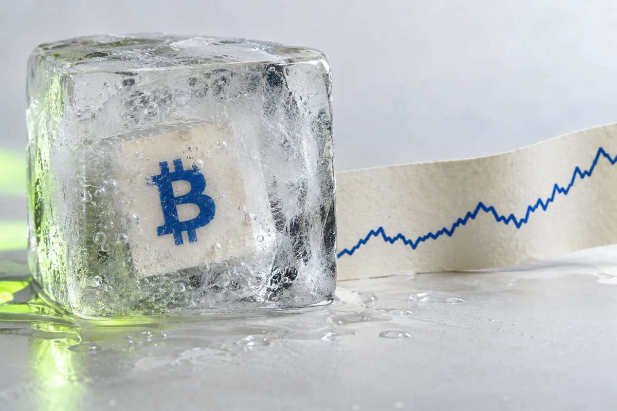 Bitcoin price card frozen inside clear ice beside a continuing market-price trace